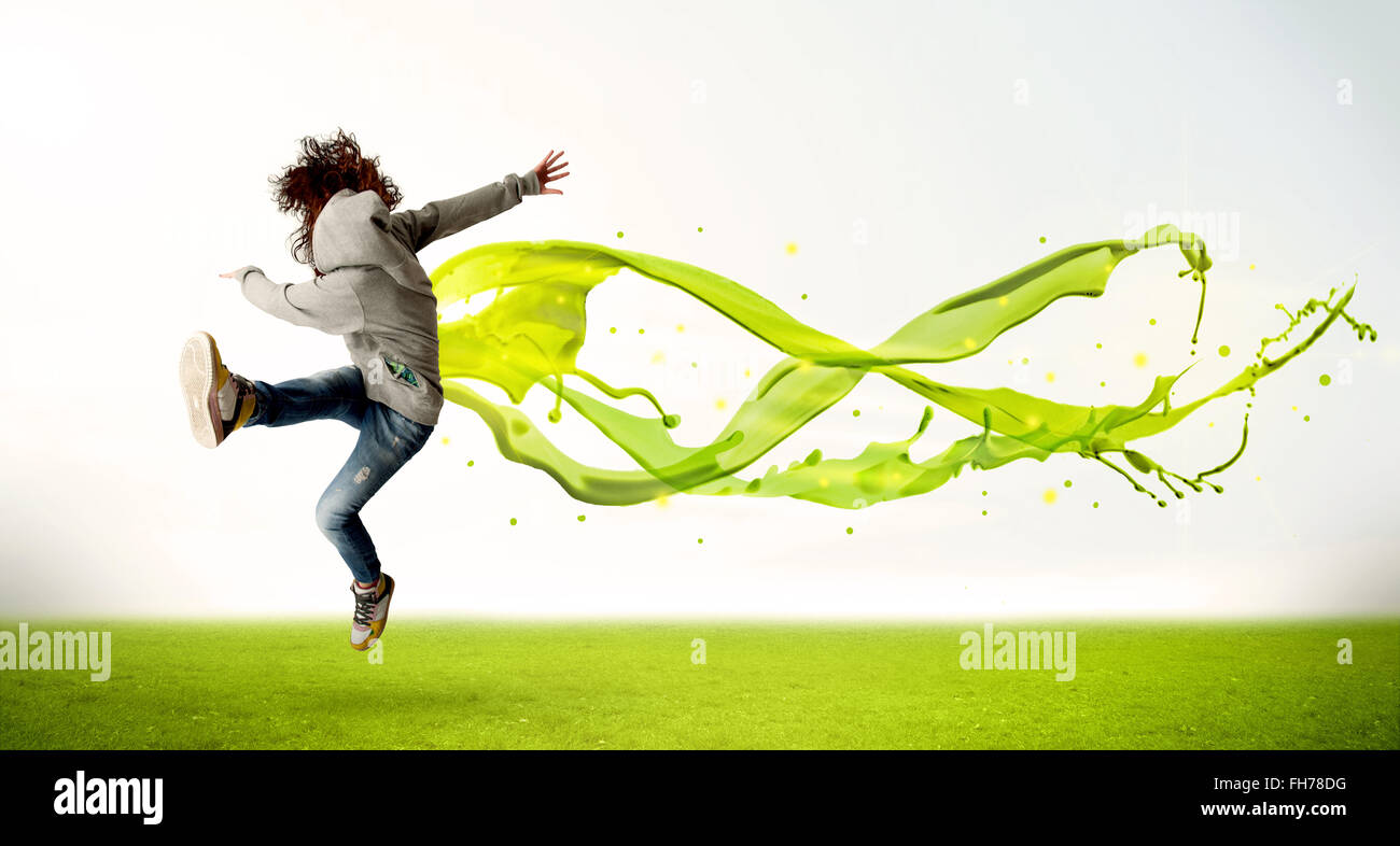 Pretty girl jumping with green abstract liquid dress Stock Photo