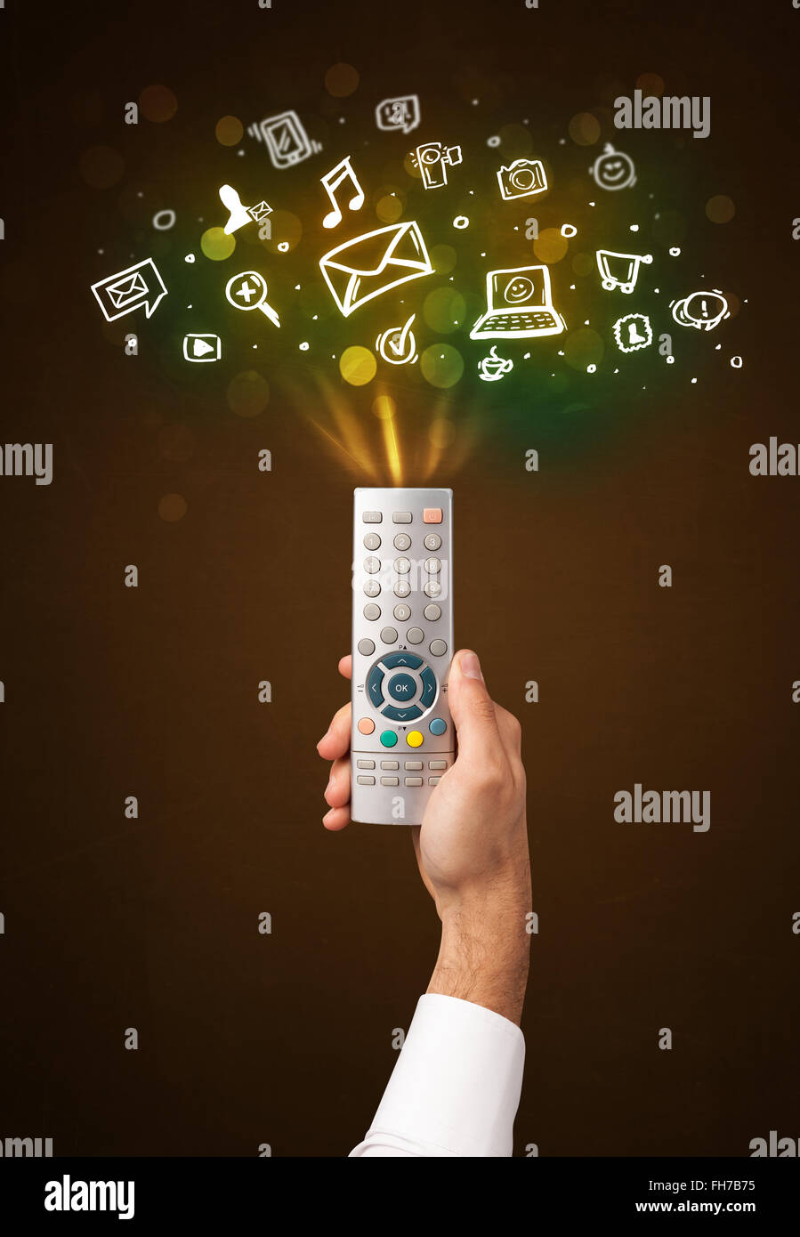 Hand with remote control and social media icons Stock Photo - Alamy