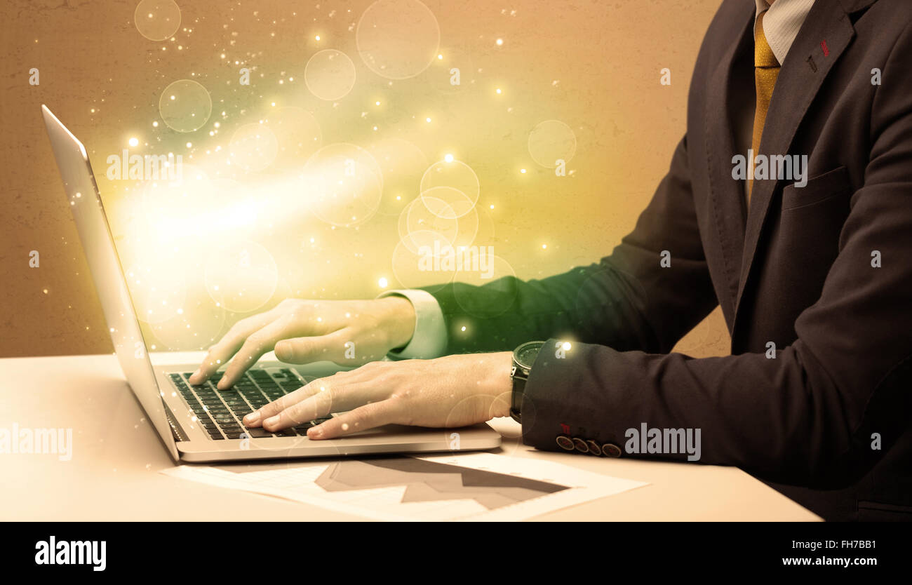 Businessman working fast on laptop Stock Photo - Alamy