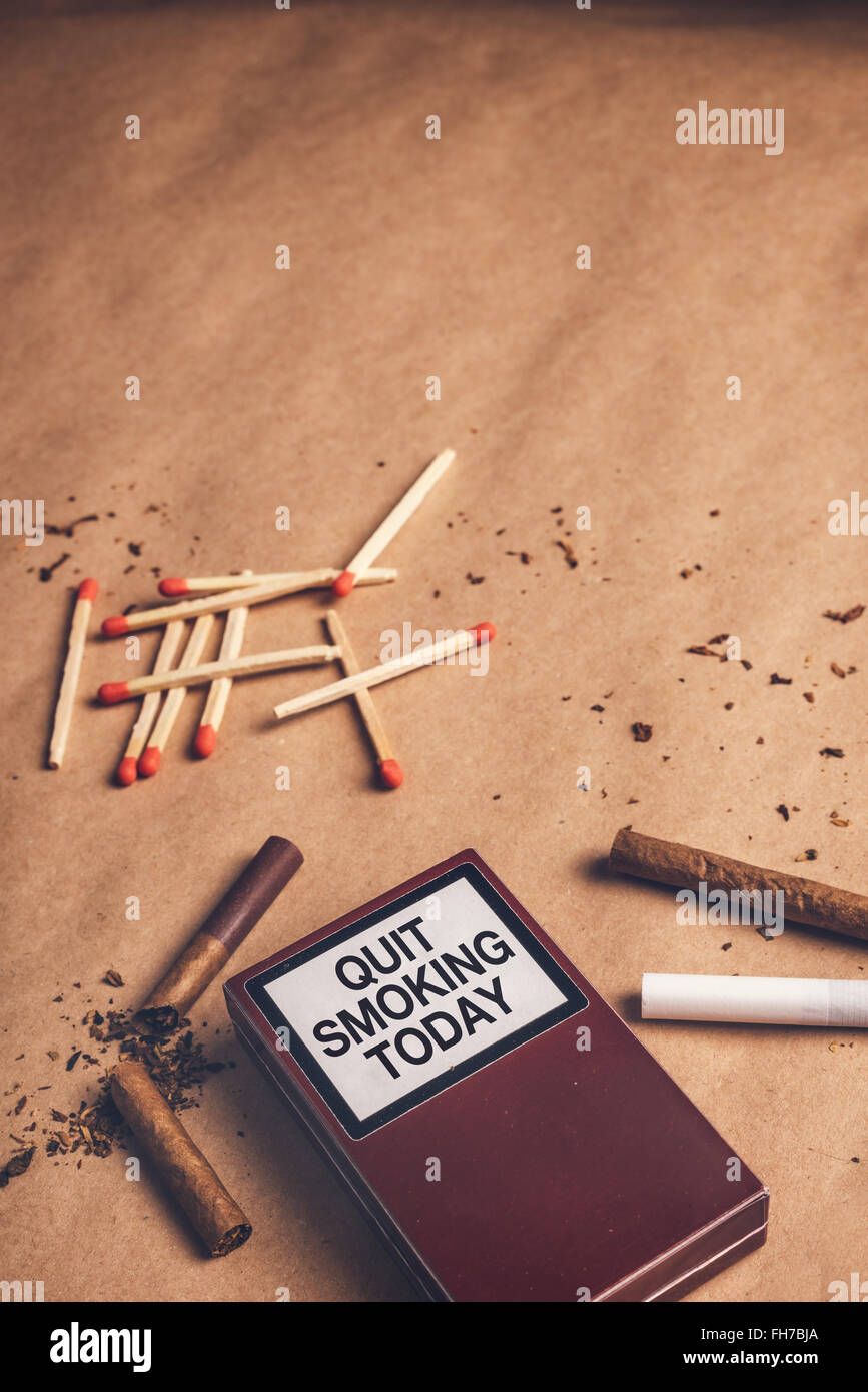 Quit smoking today concept, warm retro toned image of ashtray, pack of