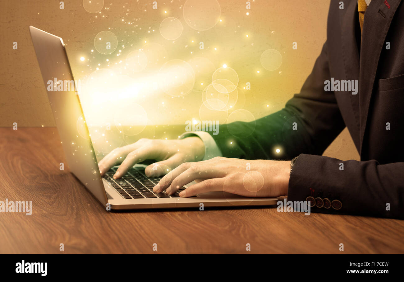 Businessman working fast on laptop Stock Photo - Alamy