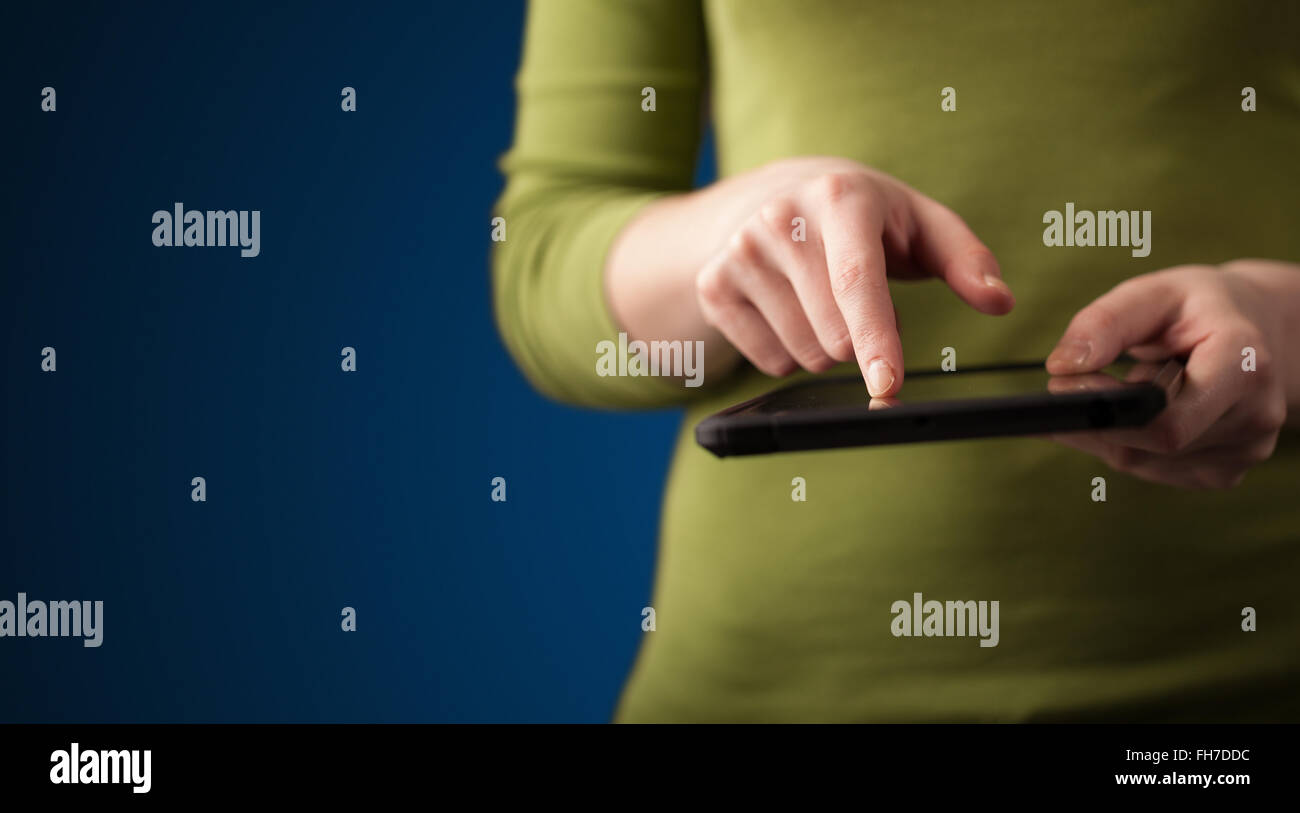 Close up of hand holding digital touchpad tablet device Stock Photo Alamy