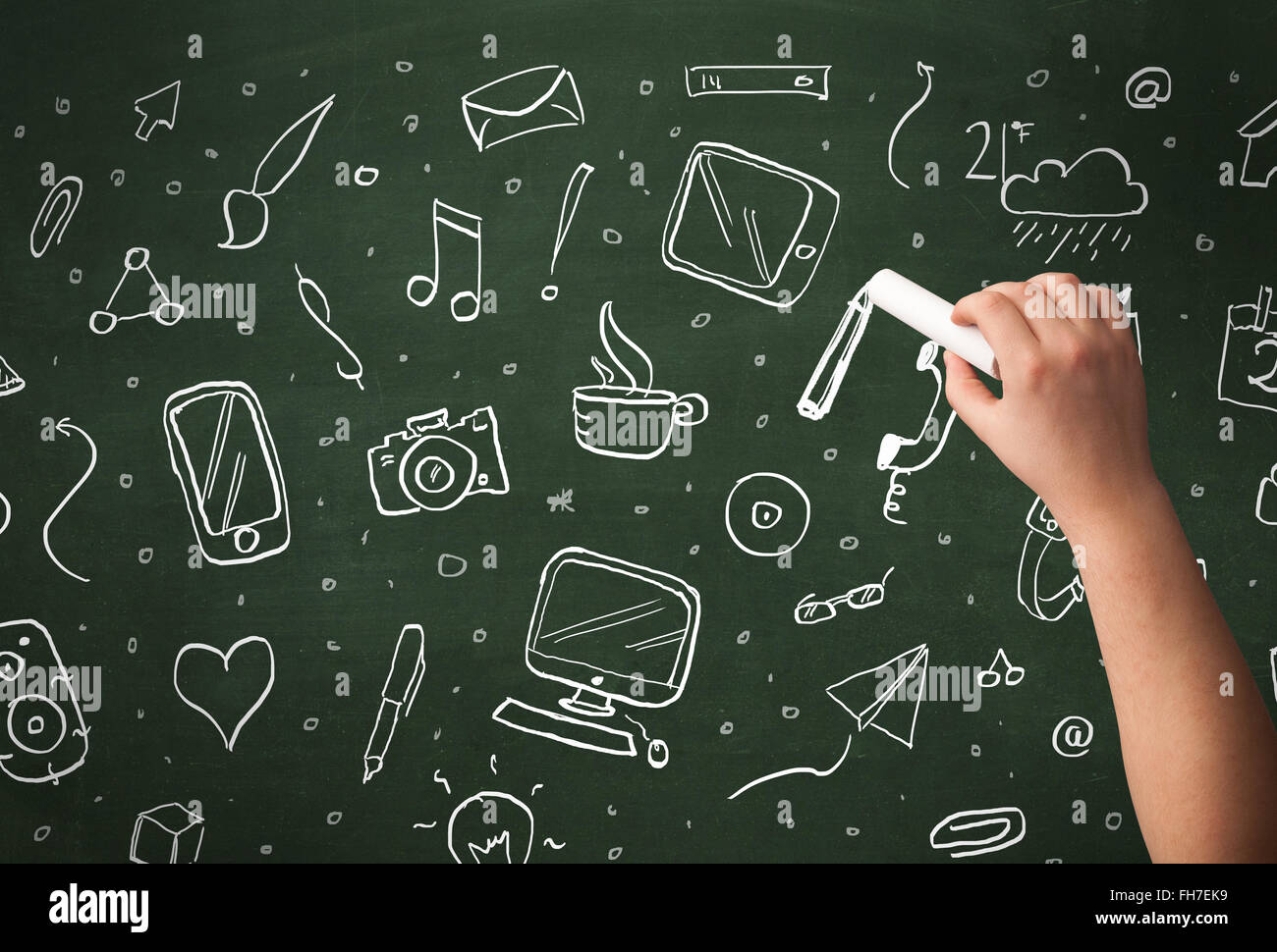 Hand writing icons on blackboard Stock Photo - Alamy