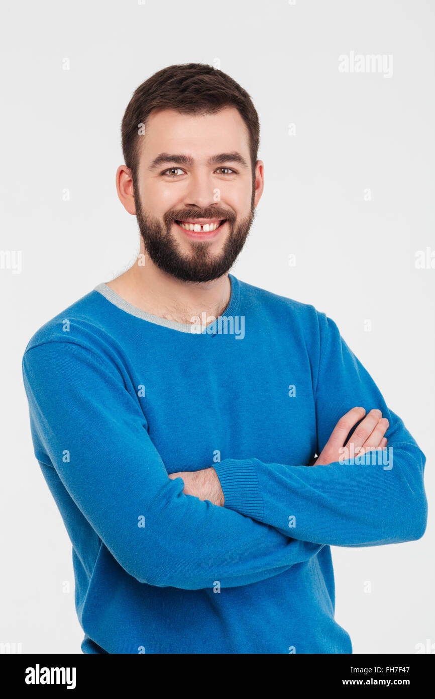 Happy casual man standing with arms folded isolated on a white ...