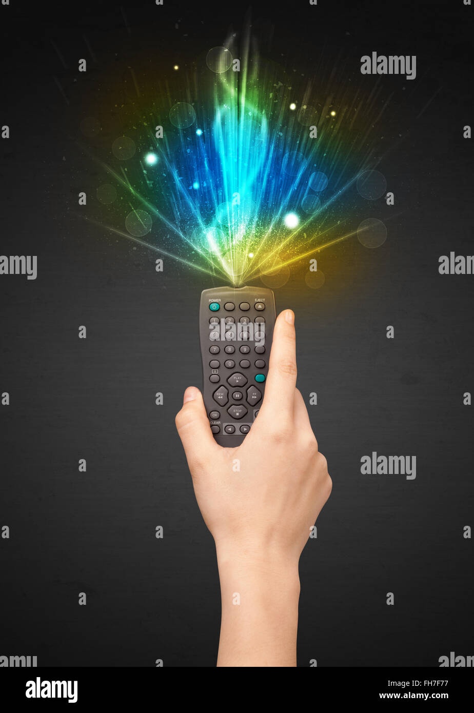 Hand with remote control and explosive signal Stock Photo