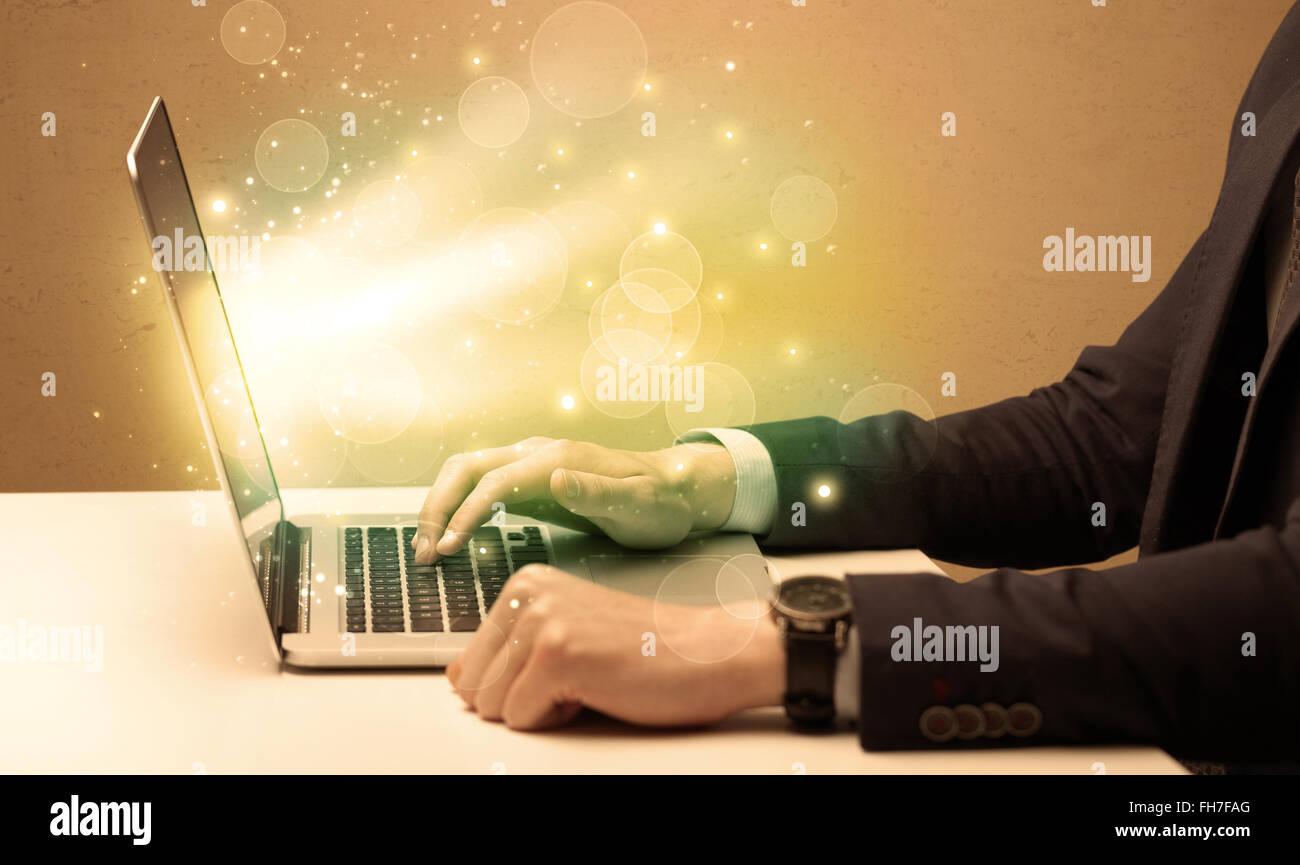 Businessman working fast on laptop Stock Photo - Alamy