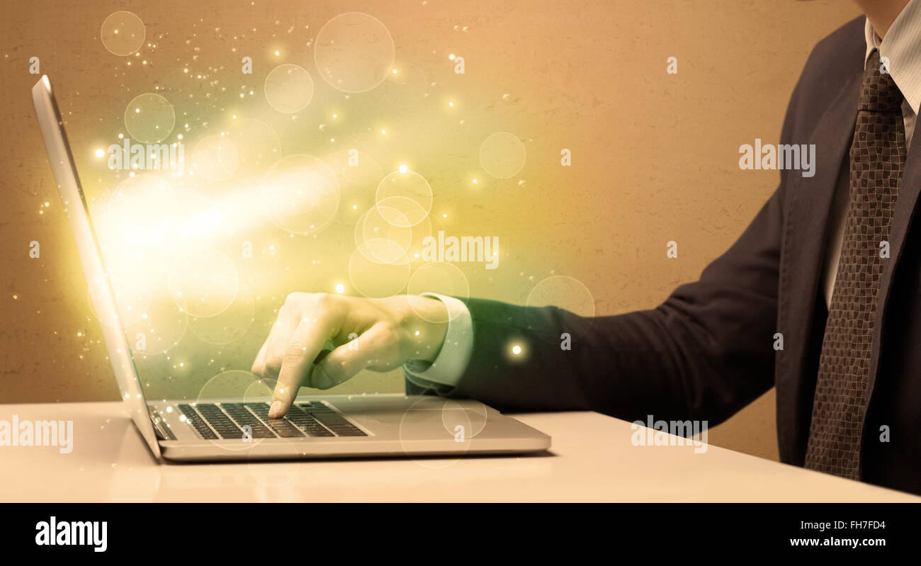 Businessman working fast on laptop Stock Photo - Alamy