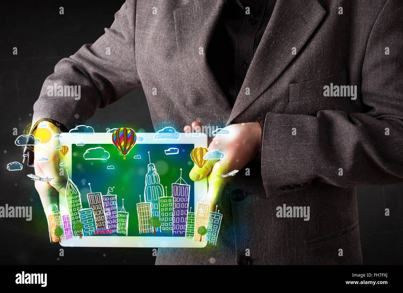 Young person showing tablet with hand drawn cityscape Stock Photo