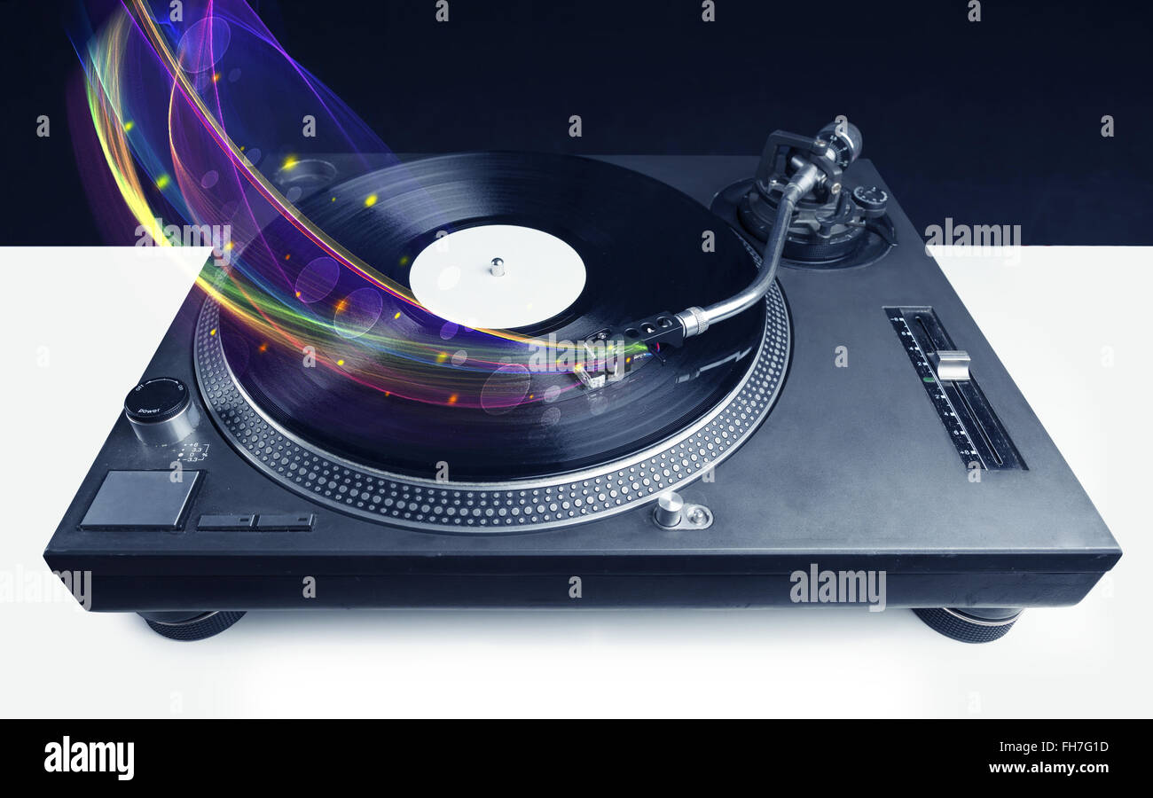 Turntable playing vinyl with glowing abstract lines Stock Photo