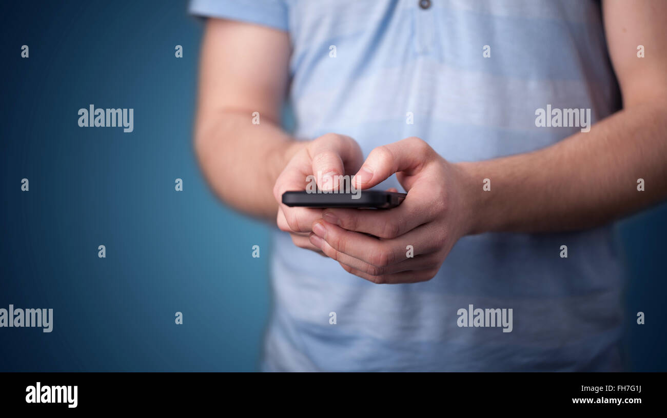 Young man holding smarthphone in hand Stock Photo - Alamy