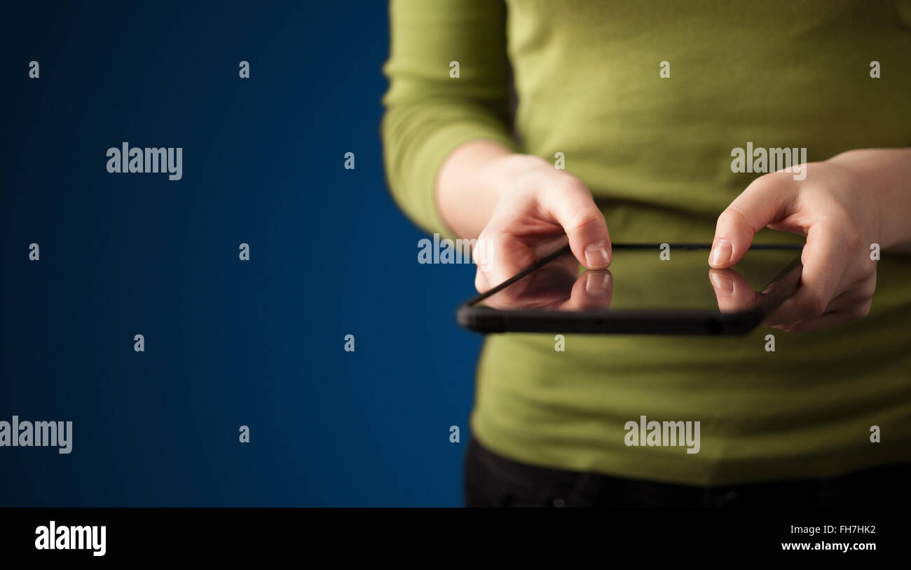 Close up of hand holding digital touchpad tablet device Stock Photo Alamy
