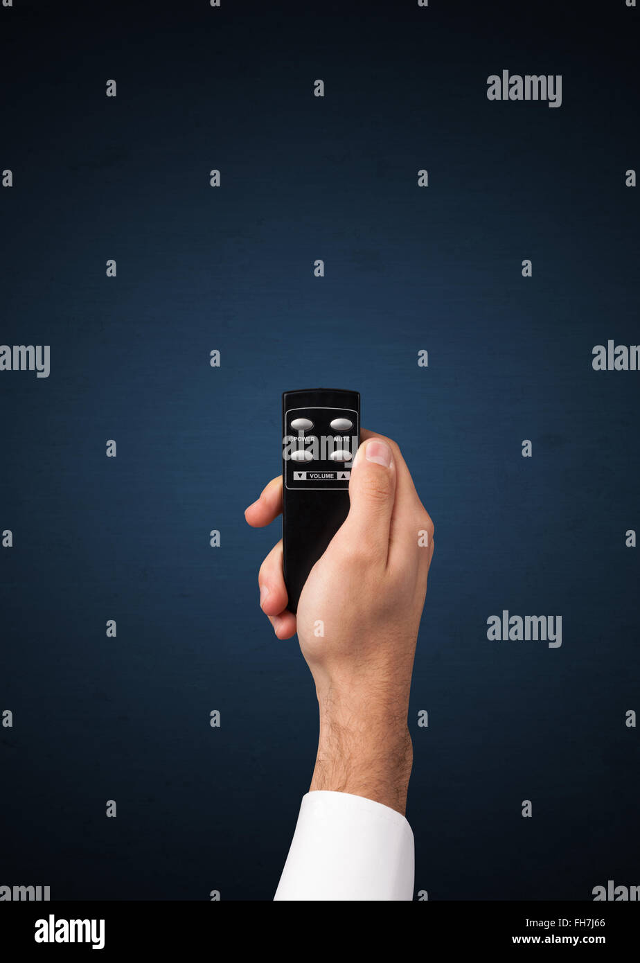 Hand with remote control Stock Photo - Alamy
