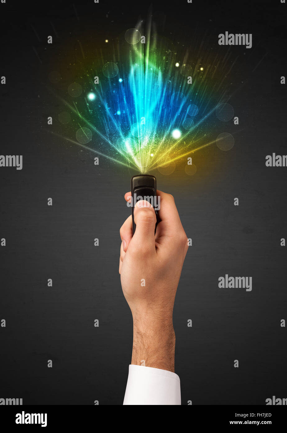 Hand with remote control and explosive signal Stock Photo - Alamy