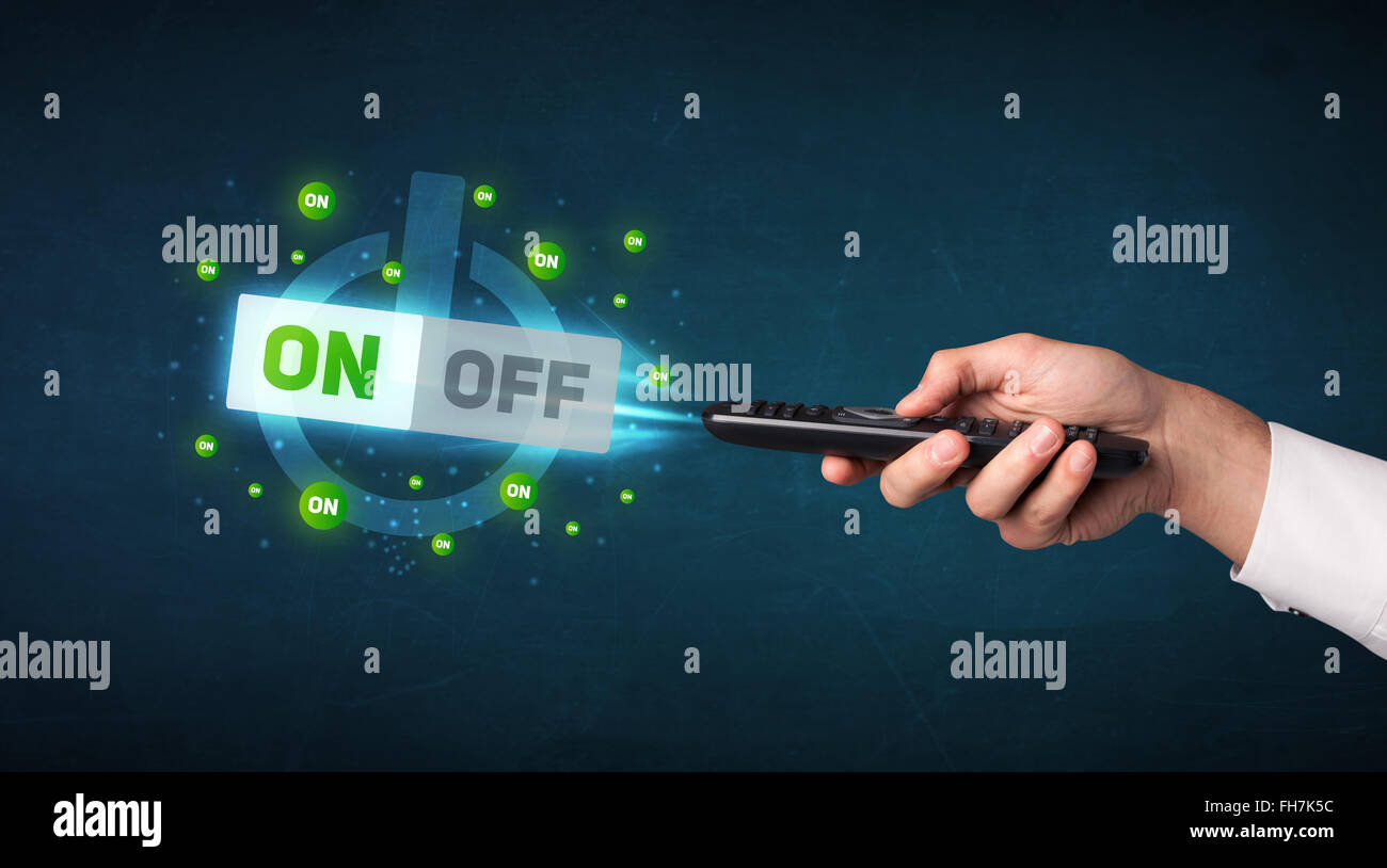 Hand with remote control and on-off signals Stock Photo - Alamy
