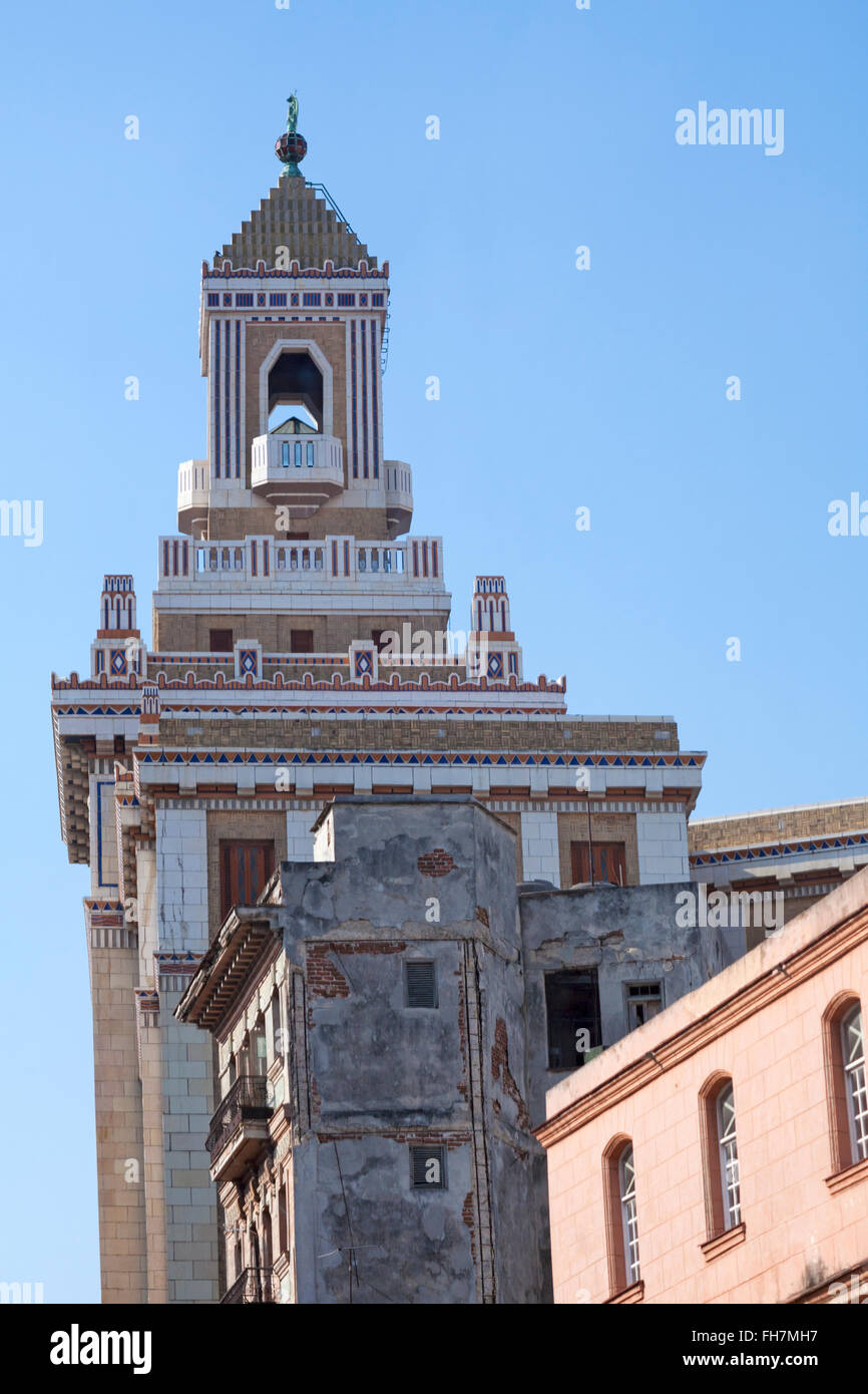 Contrasts of the grandeur of Bacardi Palace building, Edificio Bacardi, art deco style with nearby building in disrepair at Havana, Cuba, West Indies Stock Photo