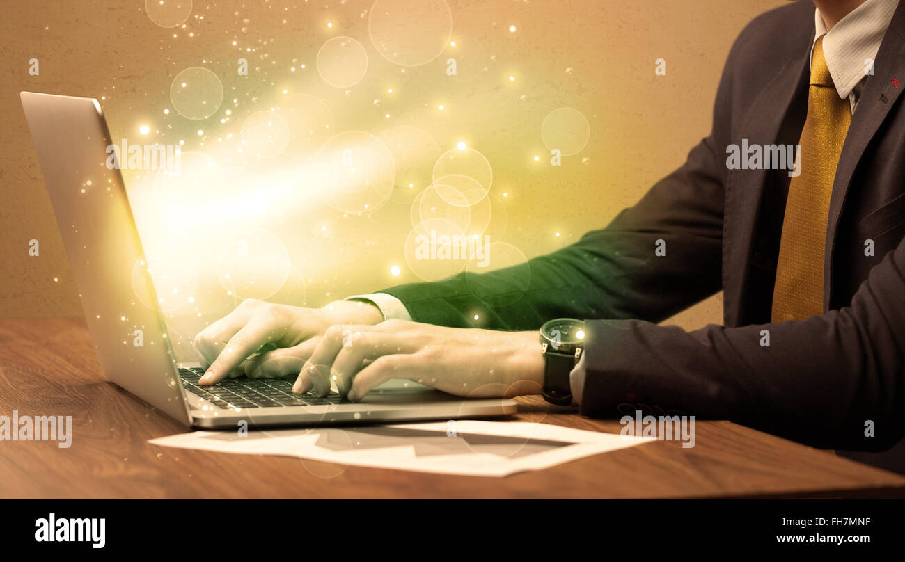 Businessman working fast on laptop Stock Photo - Alamy