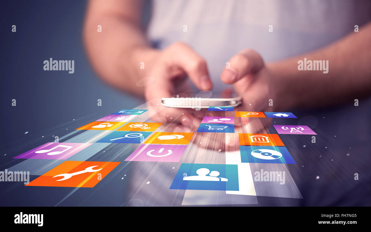 Man holding smart phone with colorful application icons Stock Photo - Alamy