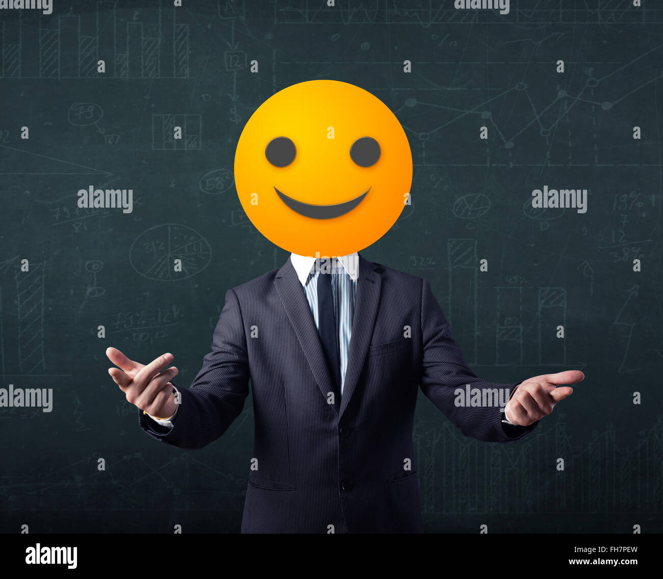 businessman wears yellow smiley face Stock Photo