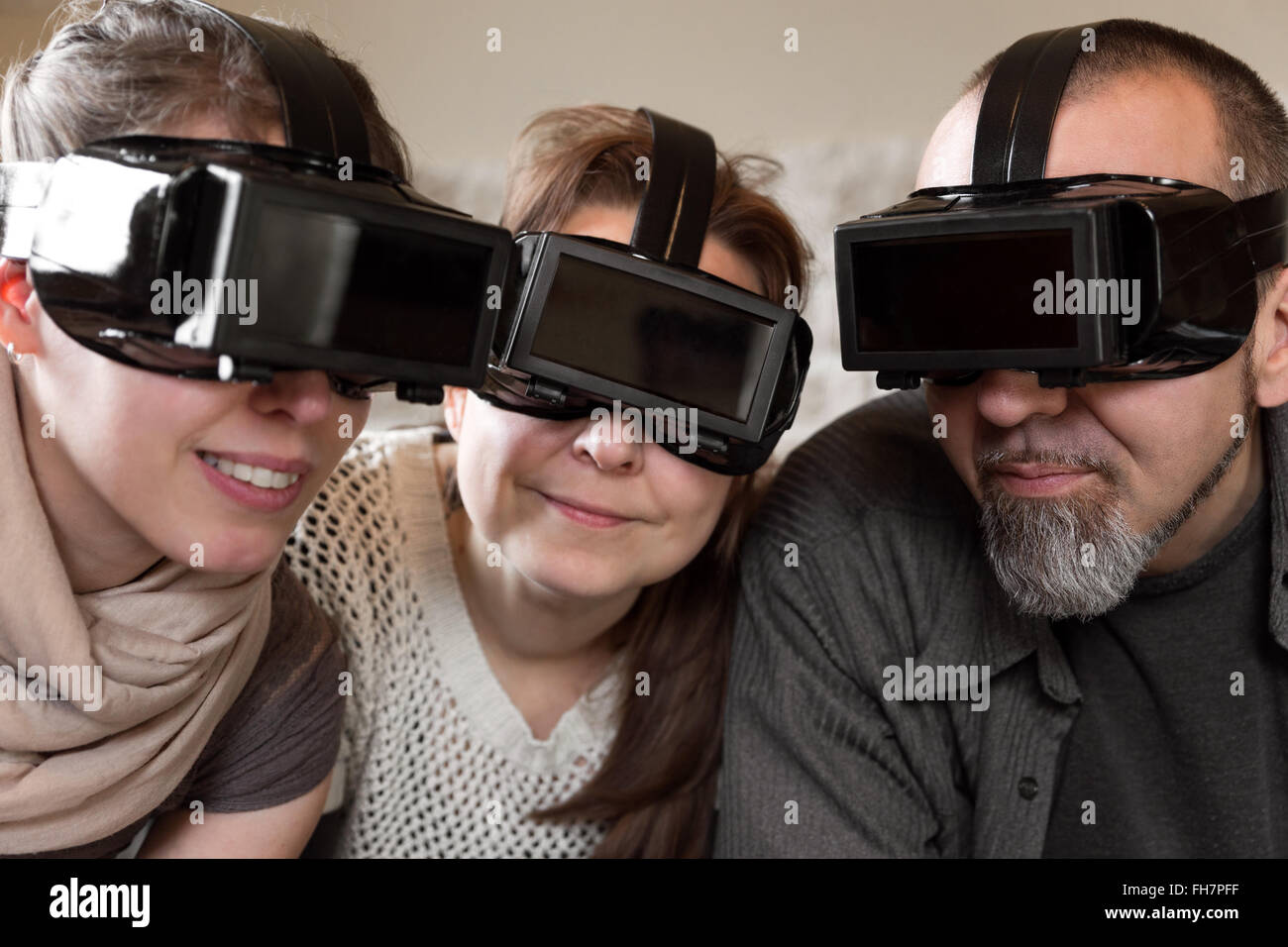 portrait of three persons with virtual reality glasses Stock Photo
