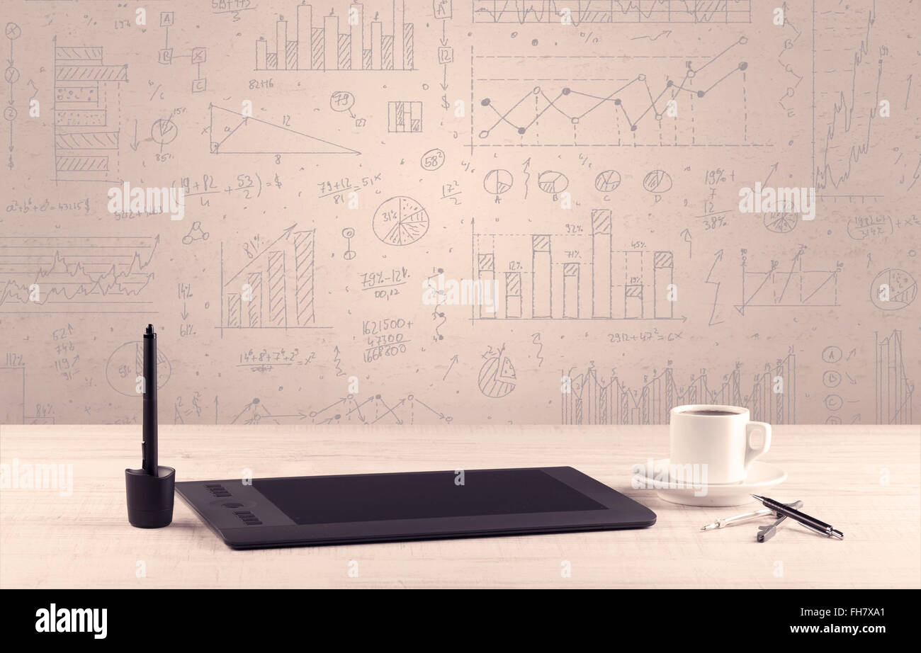 Graph charts and designer office desk Stock Photo - Alamy