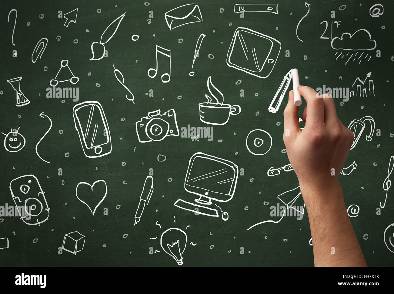 Hand writing icons on blackboard Stock Photo - Alamy