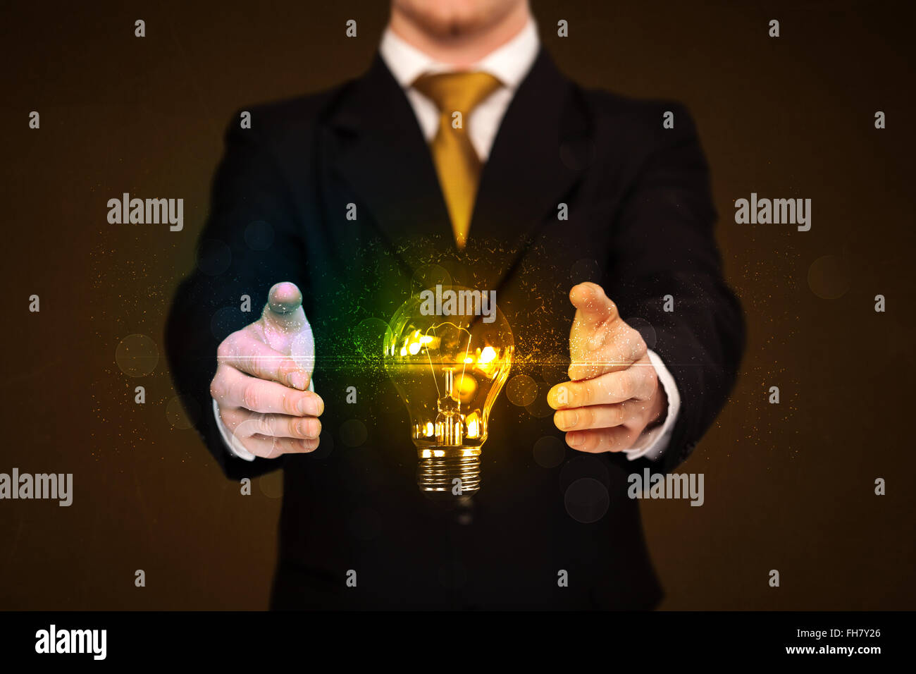 Businessman holding light bulb Stock Photo - Alamy