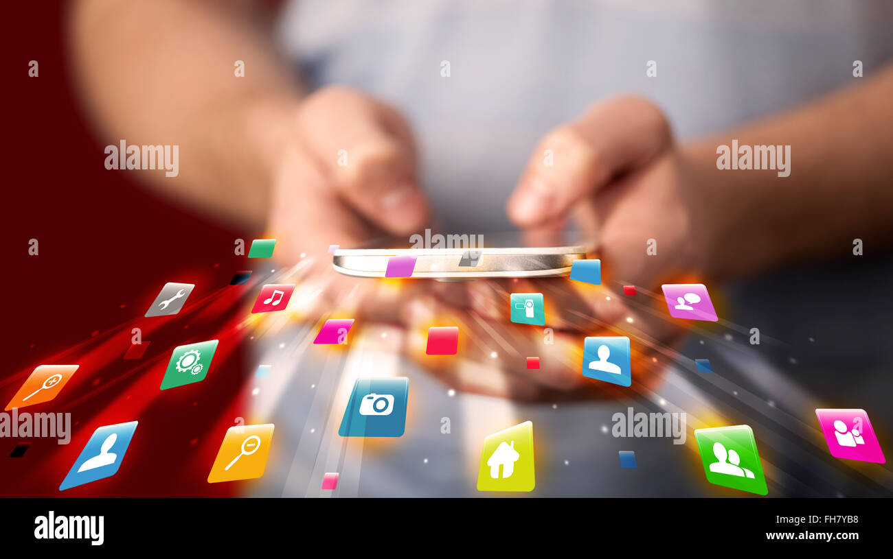 Man holding smartphone with technology application icons Stock Photo ...