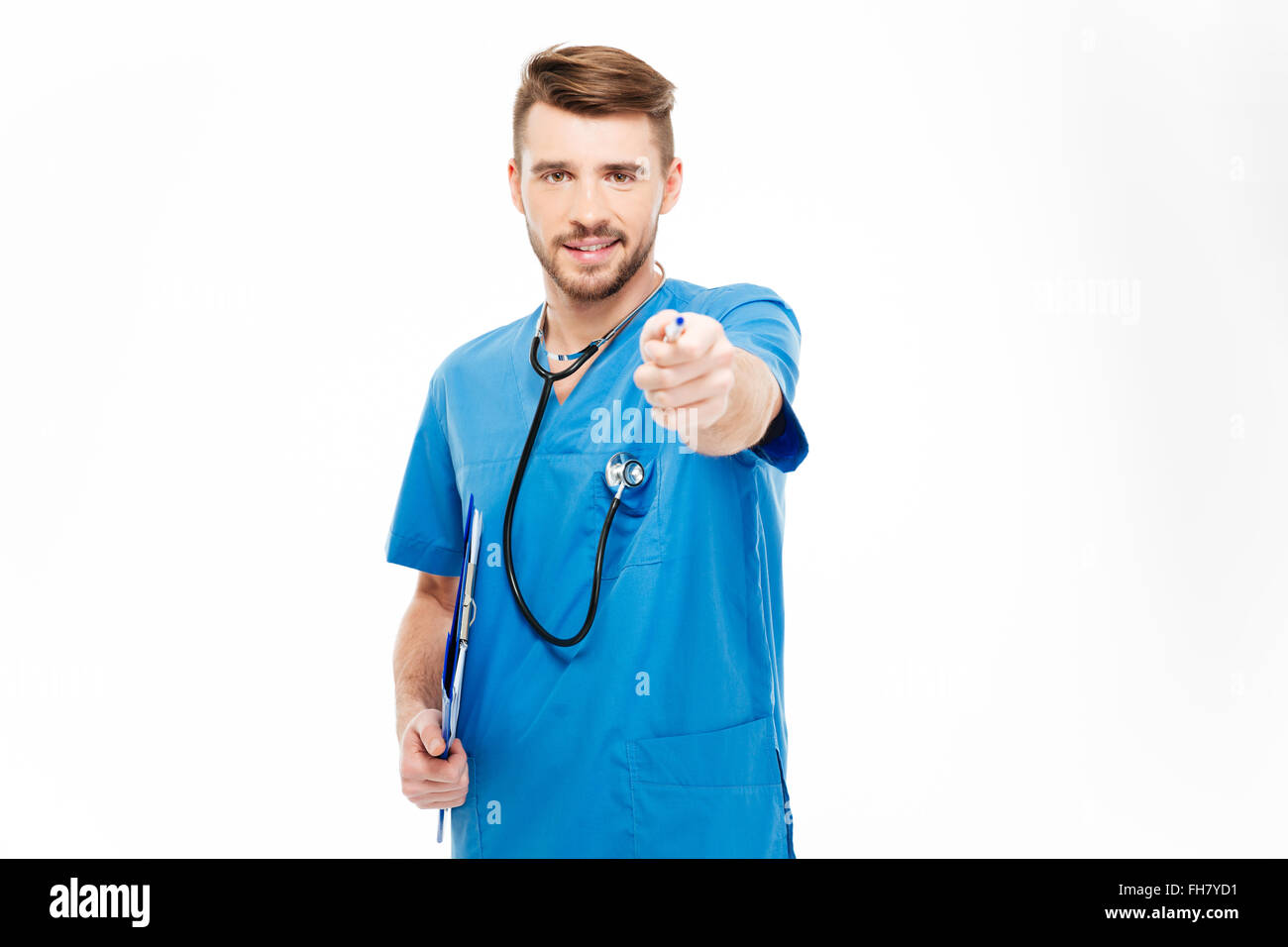Happy male doctor pointing pen at camera isolated on a white background Stock Photo
