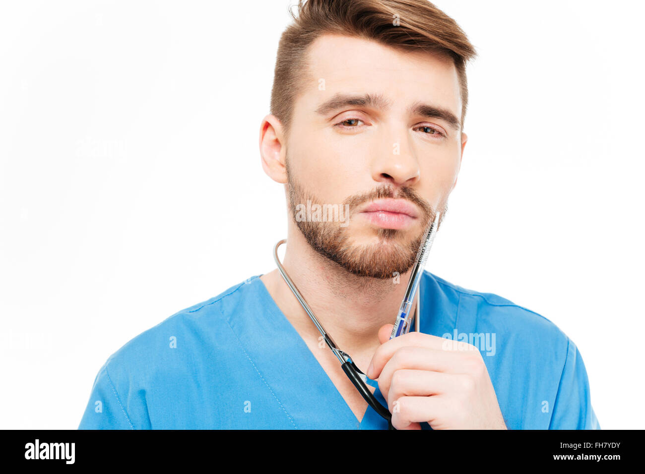 Pensive male doctor standing isolated on a white background Stock Photo