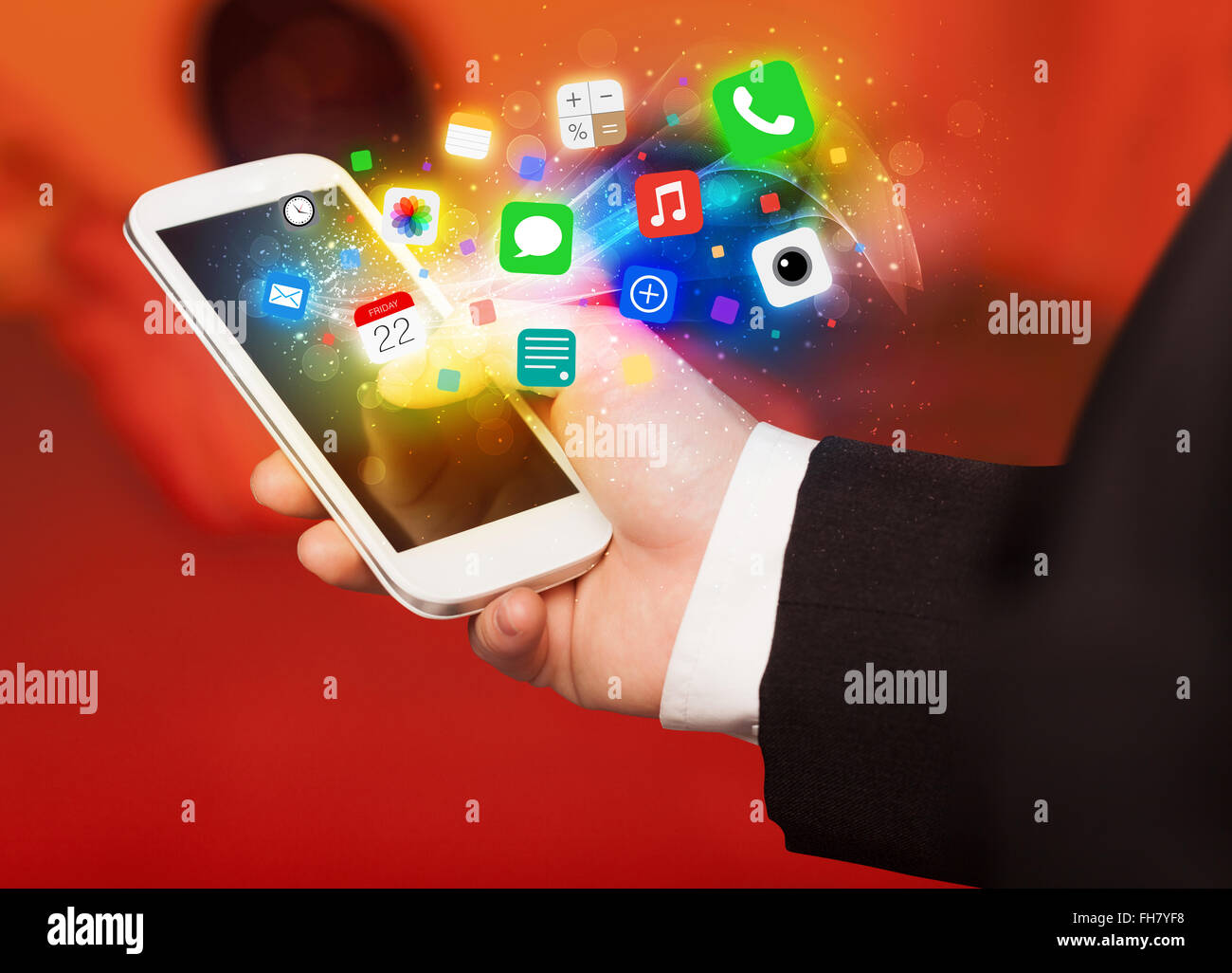 Hand holding smartphone with colorful app icons Stock Photo - Alamy