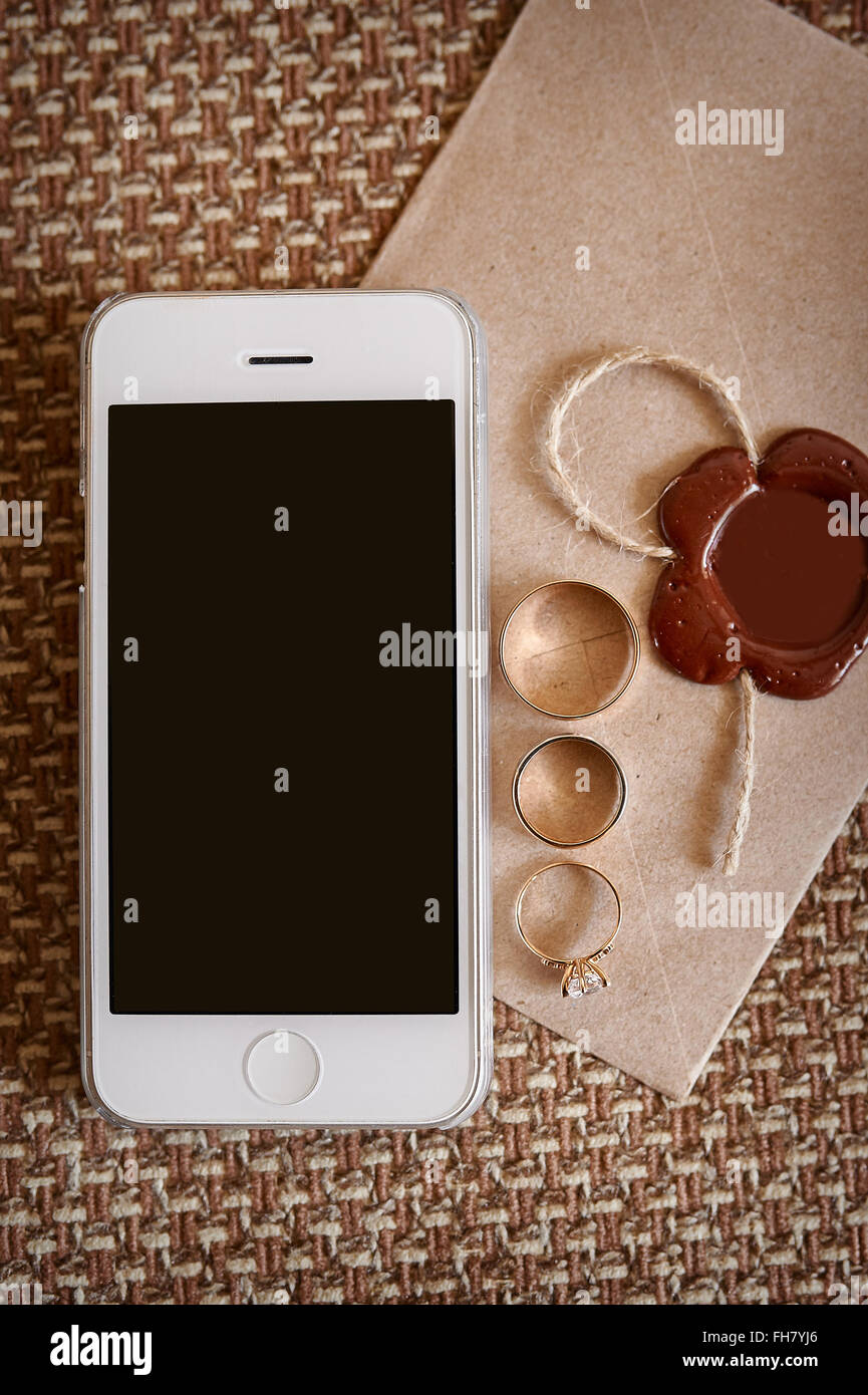 mobile phone and gold rings on envelope in wedding day Stock Photo Alamy