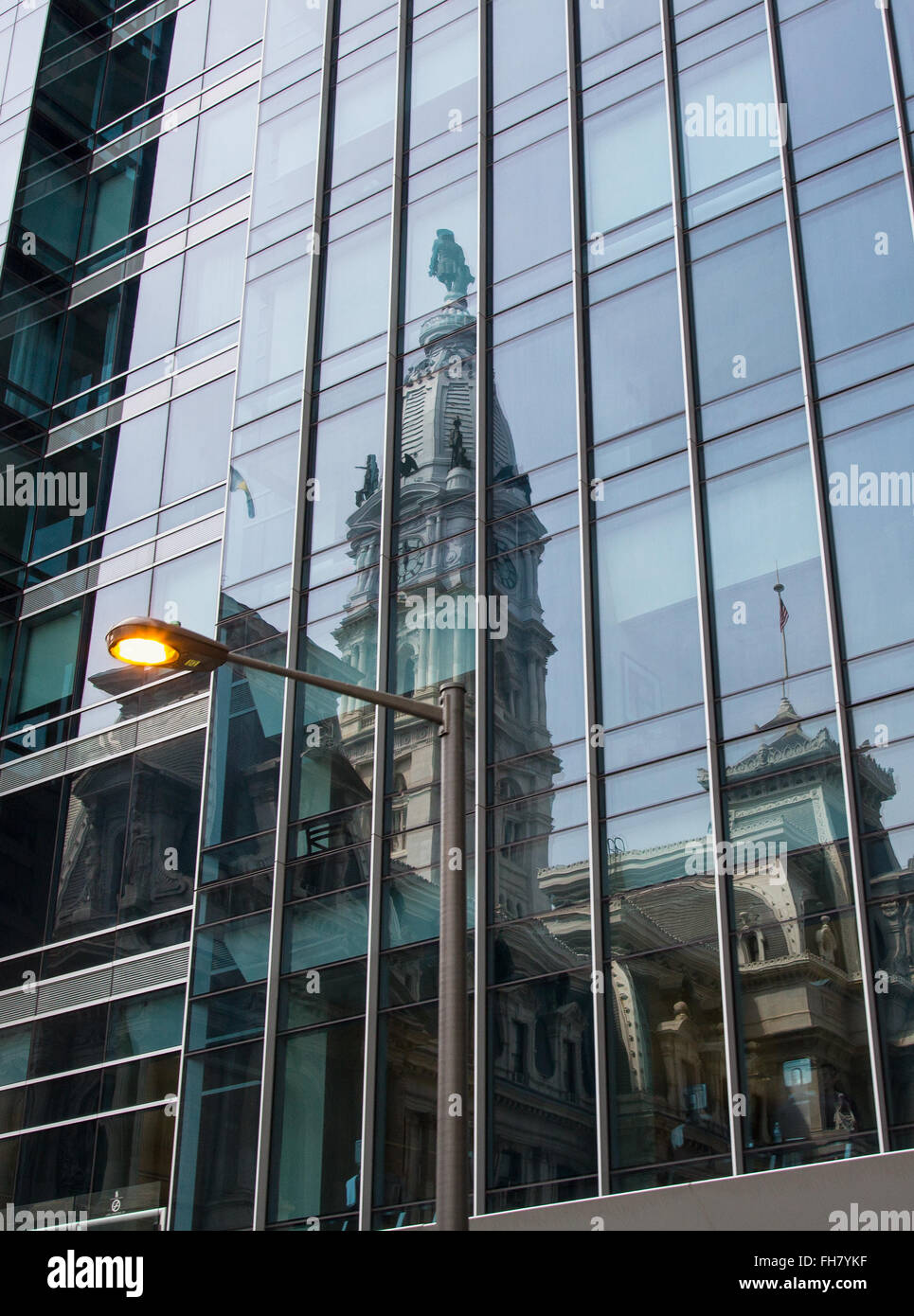 Philadelphia City Hall is seen reflected in the glass facade of a near by office building. Stock Photo