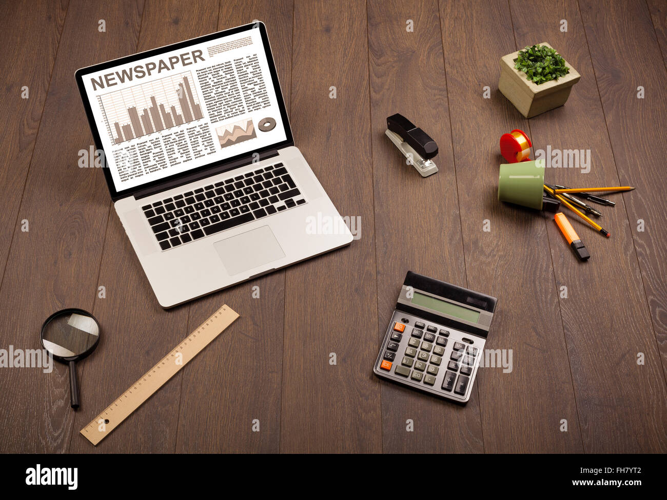 Business laptop with stock market report on wooden desk Stock Photo