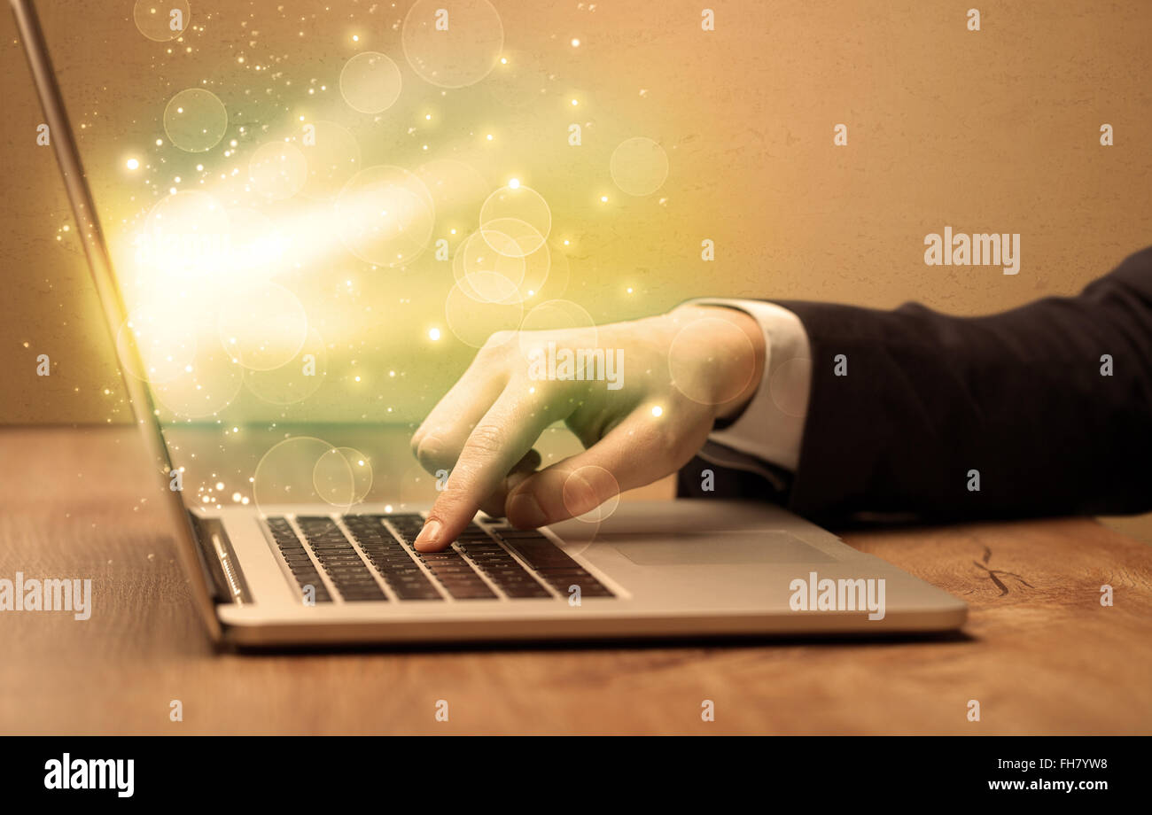 Businessman working fast on laptop Stock Photo - Alamy