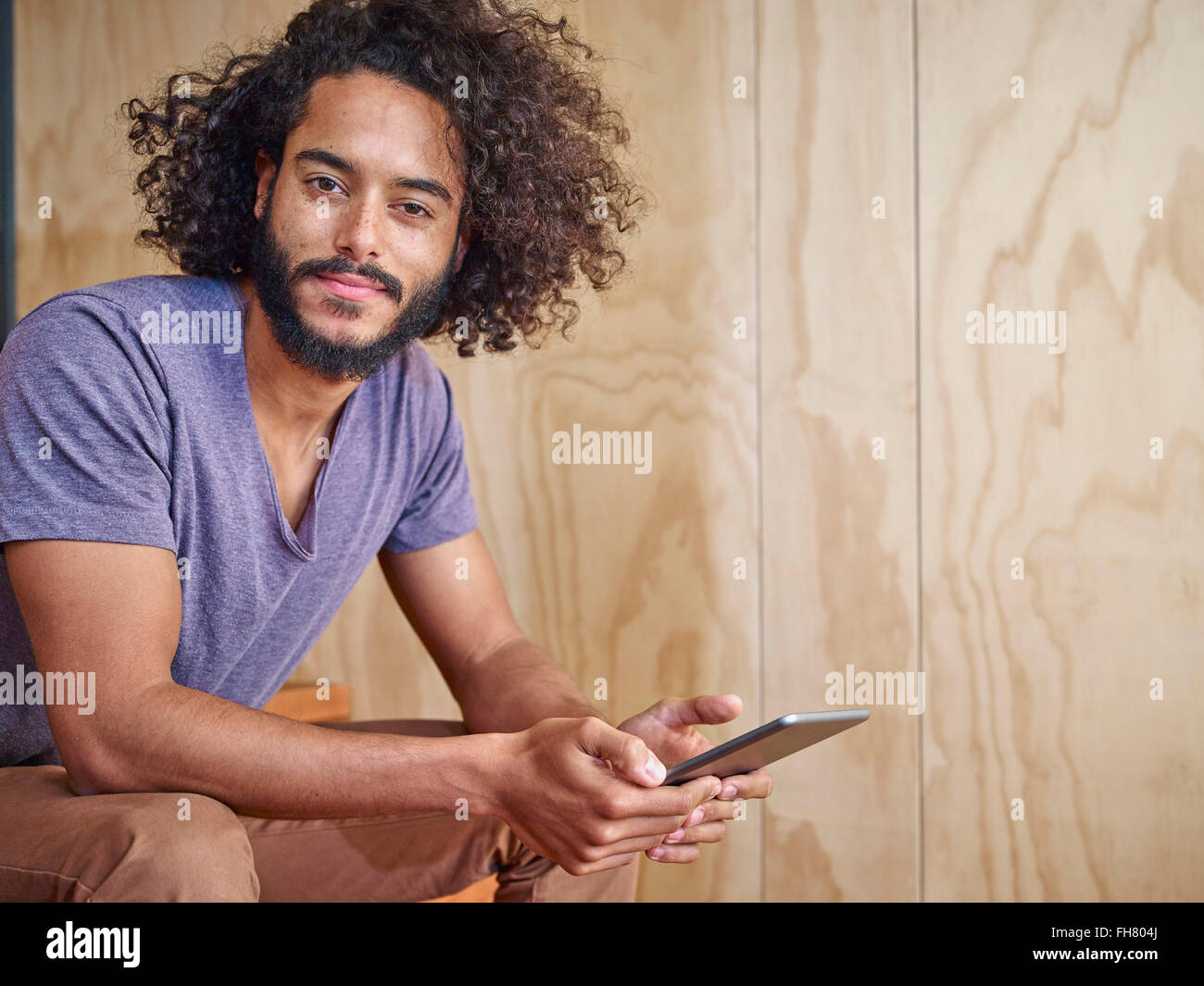 Portrait of young man holding digital tablet Stock Photo