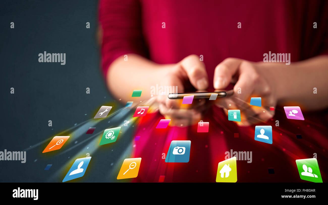Man holding smartphone with technology application icons Stock Photo ...