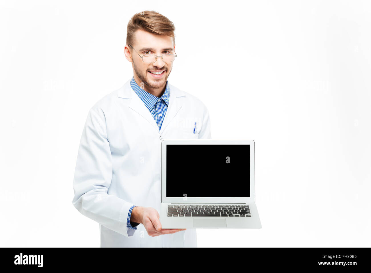 Male doctor showing blank laptop computer screen isolated on a white background Stock Photo