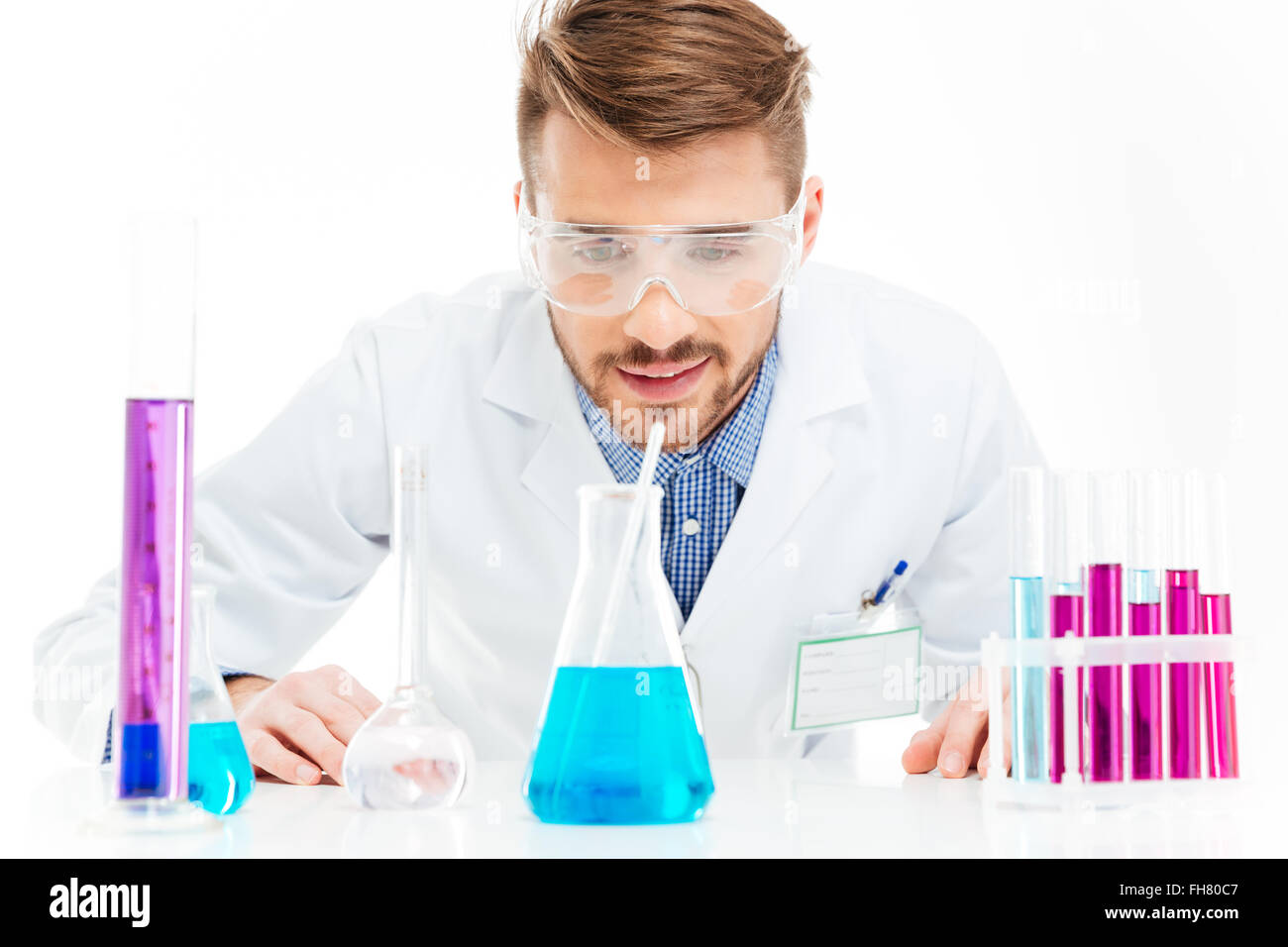 Man pouring chemicals isolated on a white background Stock Photo