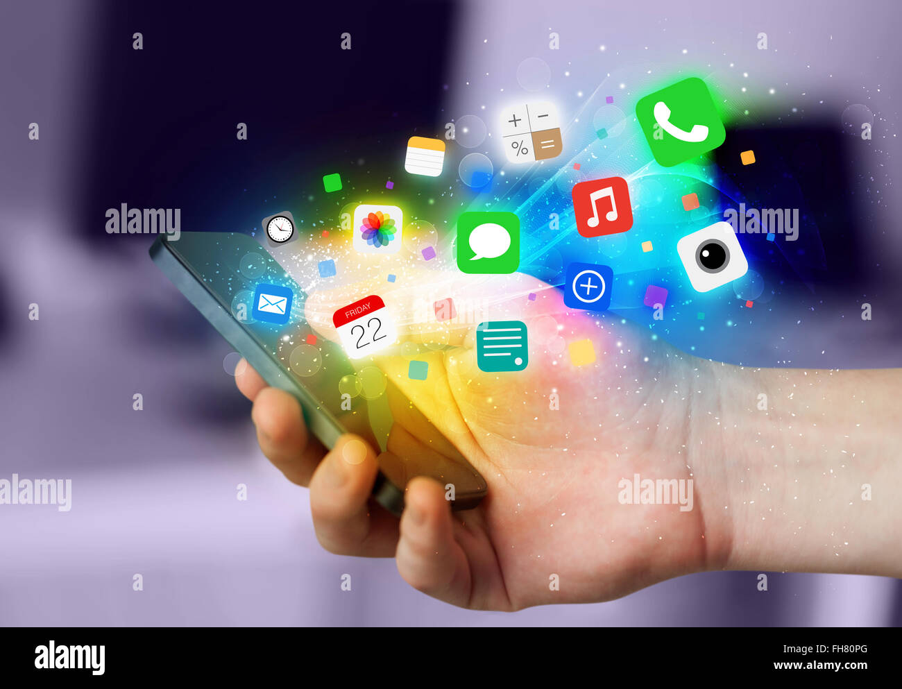 Hand holding smartphone with colorful app icons Stock Photo - Alamy