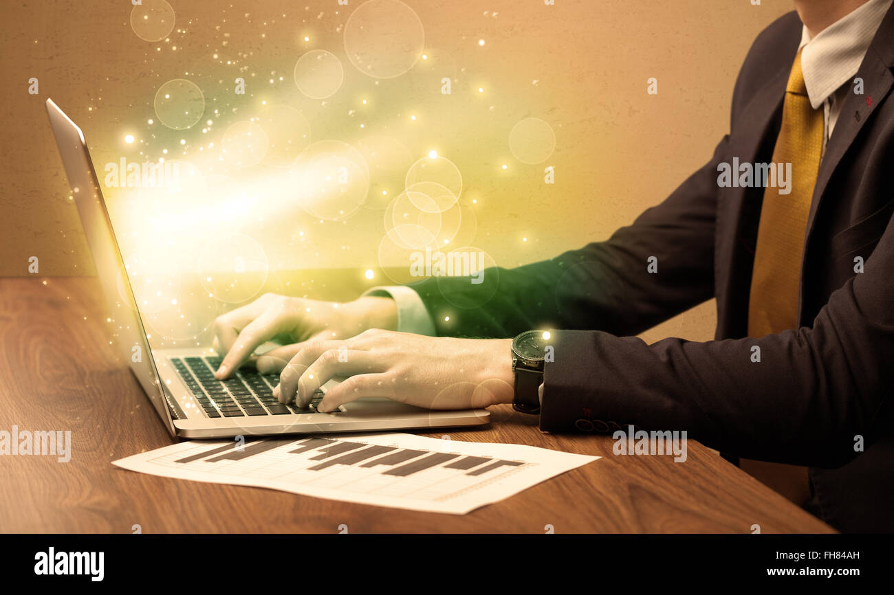 Businessman working fast on laptop Stock Photo - Alamy