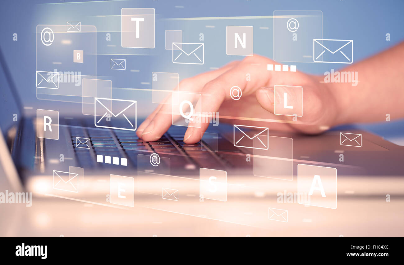 Hand typing on keyboard with digital tech icons Stock Photo - Alamy