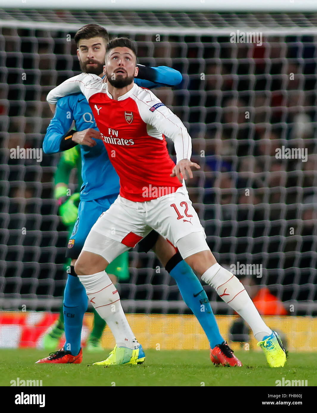 London, UK. 23rd Feb, 2016. Gerard Pique of Barcelona and Olivier Giroud of Arsenal compete for the ball during the Champions League match between Arsenal and Barcelona at The Emirates Stadium on February 23, 2016 in London, United Kingdom. Credit:  Mitchell Gunn/ESPA/Alamy Live News Stock Photo