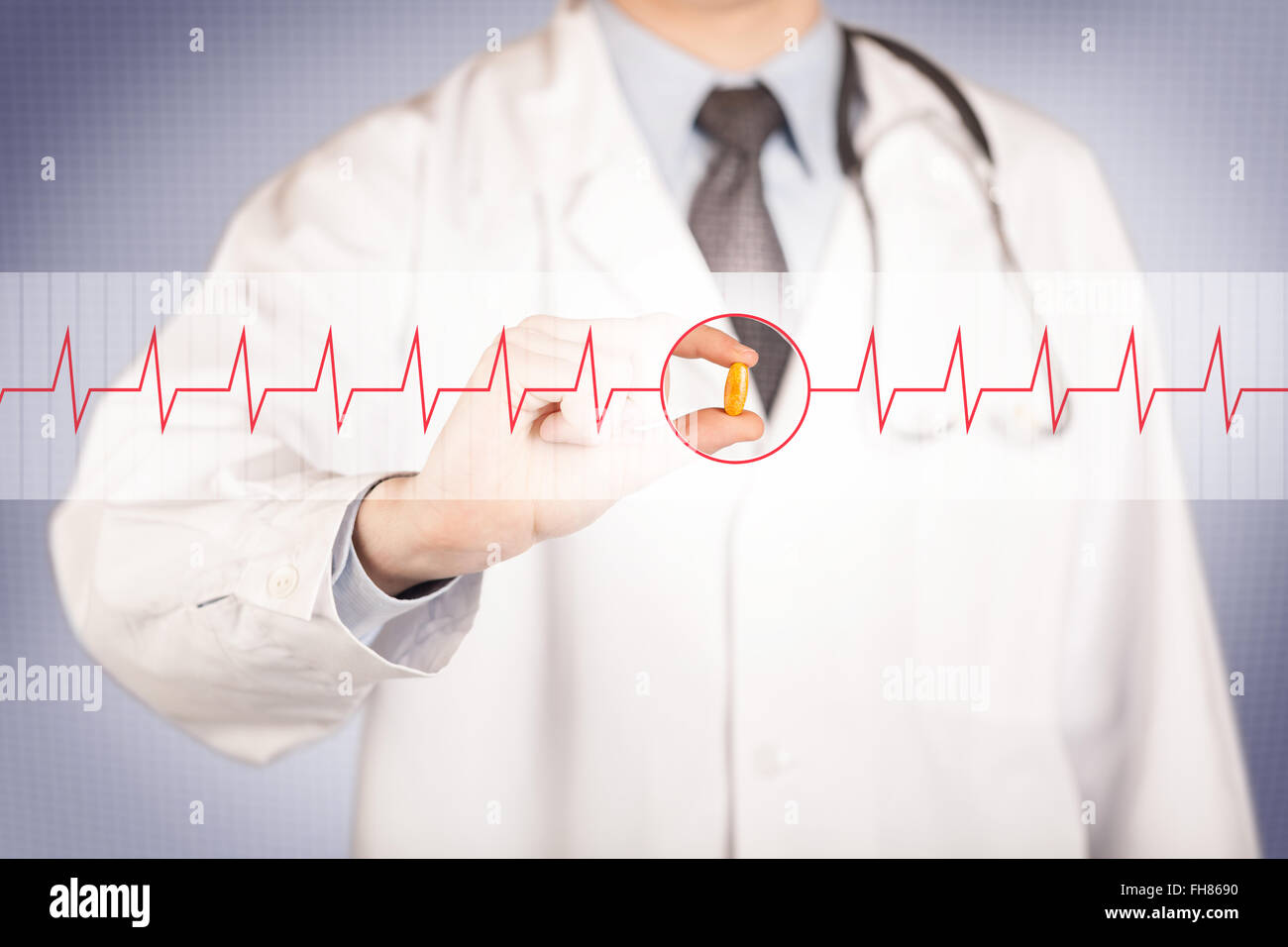 A doctor holding a heart pill Stock Photo - Alamy