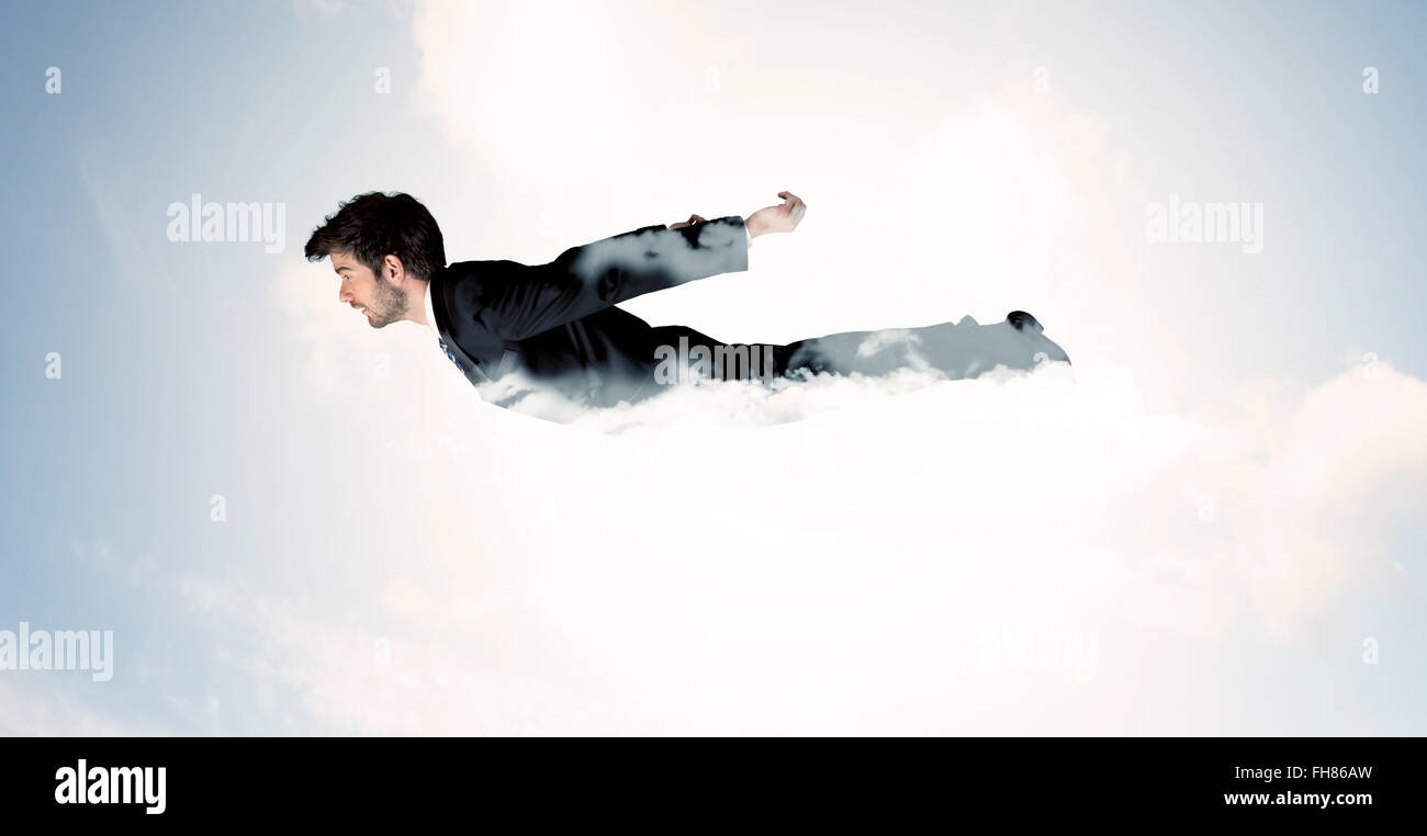Business man flying like a superhero in clouds on the sky Stock Photo