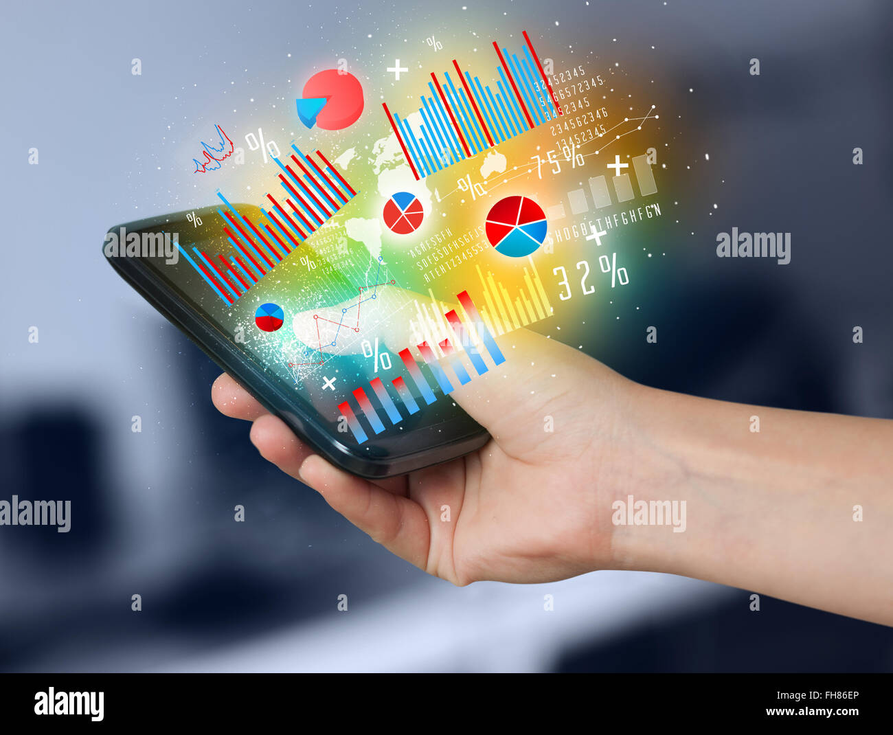 Business man holding smartphone with chart symbols Stock Photo