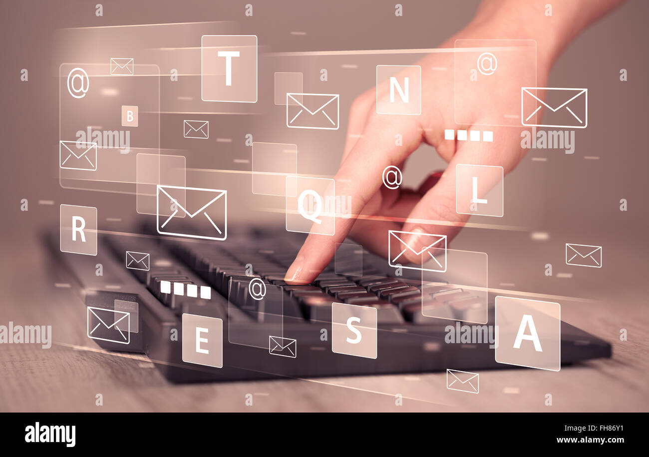 Hand typing on keyboard with digital tech icons Stock Photo - Alamy