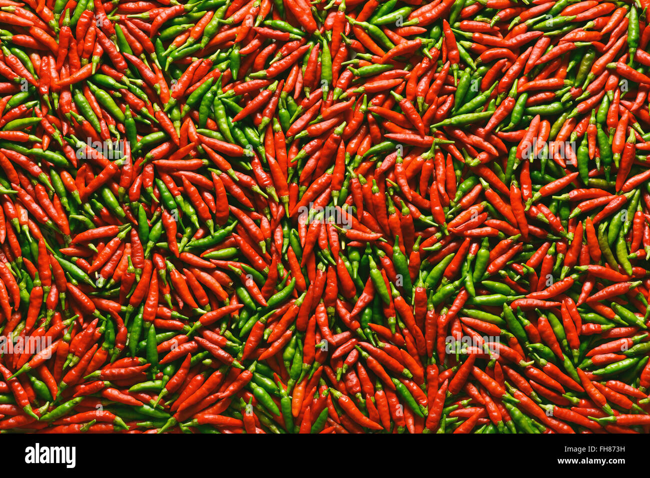 Red and green pepper over flat surface. Stock Photo