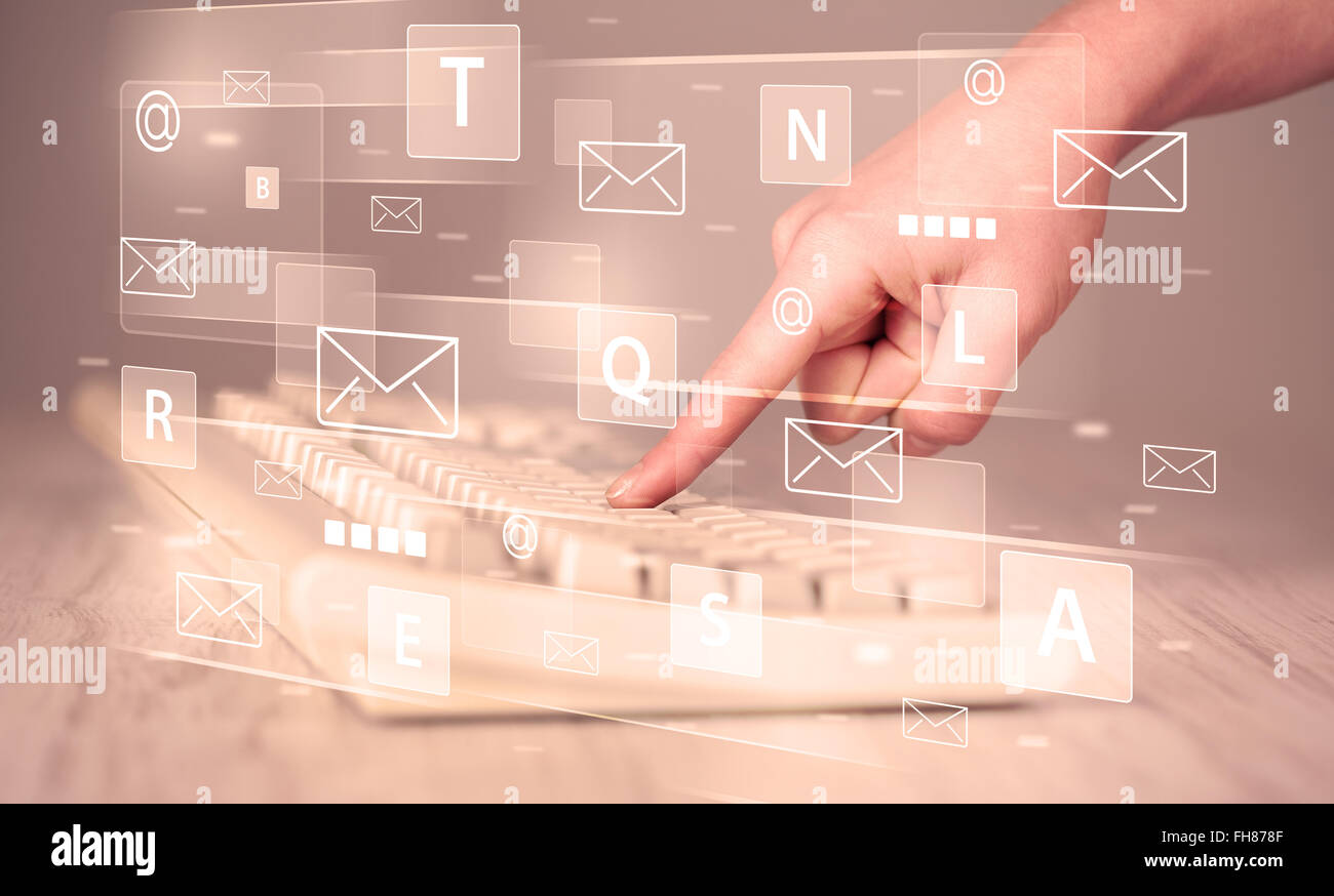 Hand typing on keyboard with digital tech icons Stock Photo - Alamy