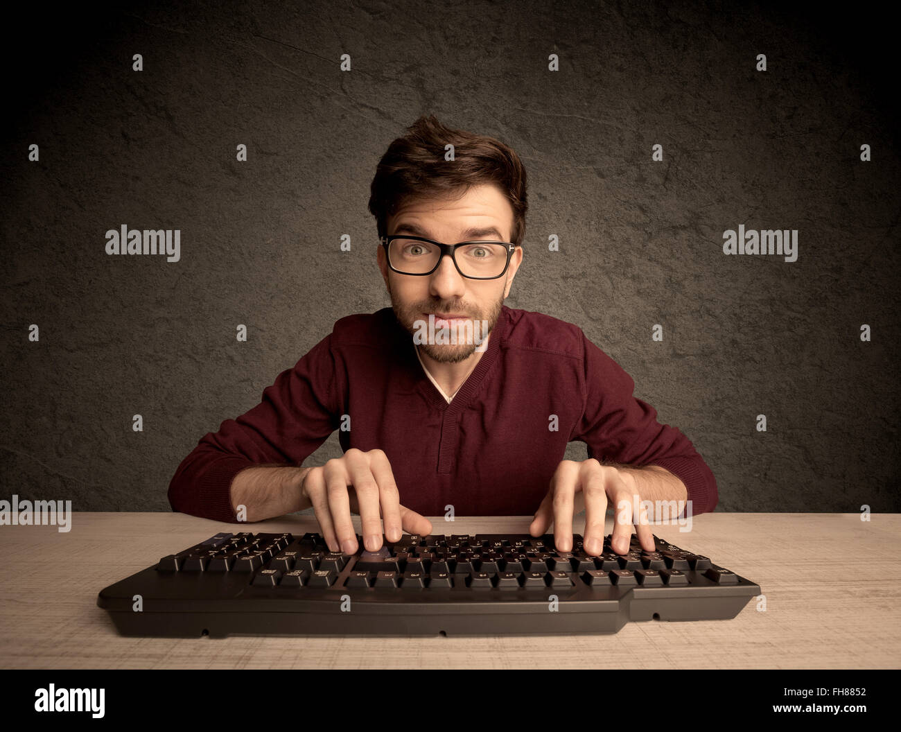 Computer geek typing on keyboard Stock Photo - Alamy
