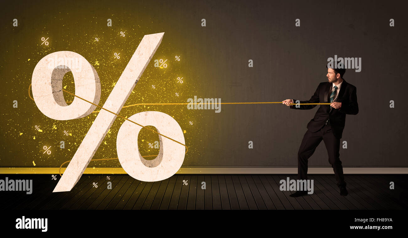 Business man pulling rope with big procent symbol sign Stock Photo - Alamy
